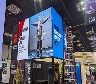 Large LED video wall setup at trade show booth with dynamic branding and event visuals